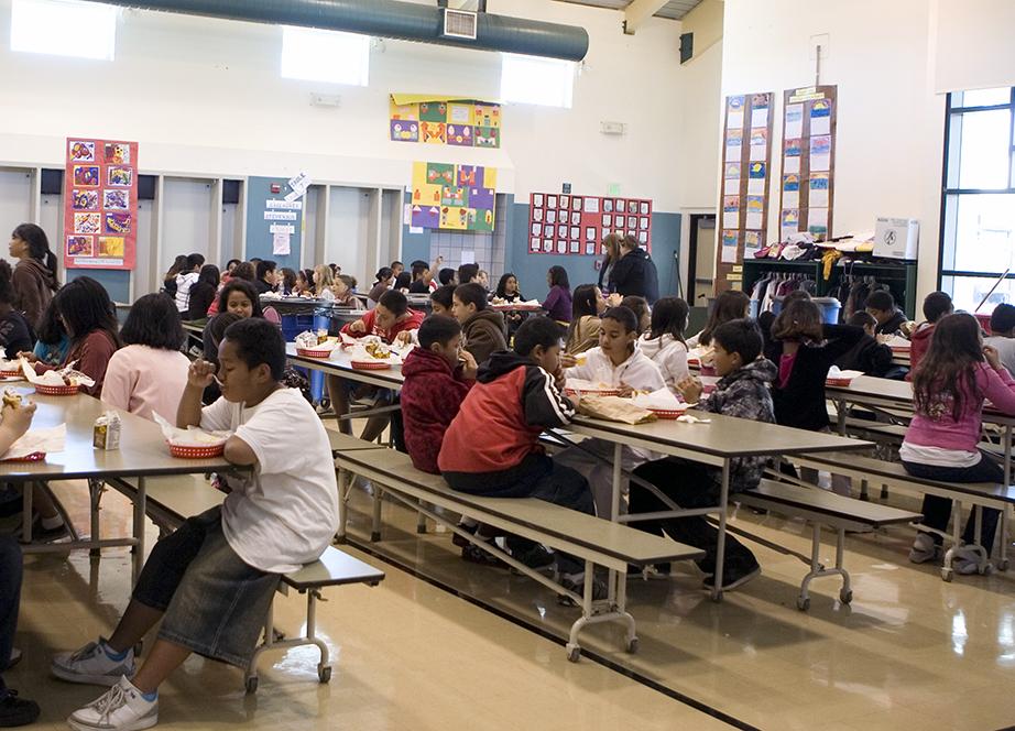A school cafeteria with children eating