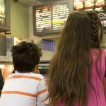 Children looking at a menu