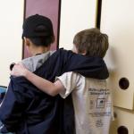 Two school children with their arms around each other