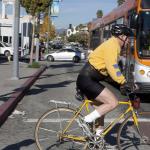 Pedestrians and a cyclist crossing a city street