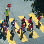 Children in a crosswalk with a crossing guard