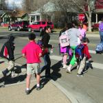 Schoolchildren in a crosswalk with a crossing guard