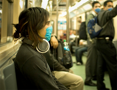 Woman on a train wearing a filter mask